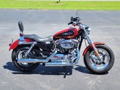 2013 Harley Davidson
Sportster XL1200C
Two-tone Candy Orange & Beer Bottle
Fuel-injected with 9,387 miles
Equipped with 1200cc motor, 5-speed transmission, passenger backrest and more!  Financing and warranty are available.  
Hawg Pen Price $7,995.00
